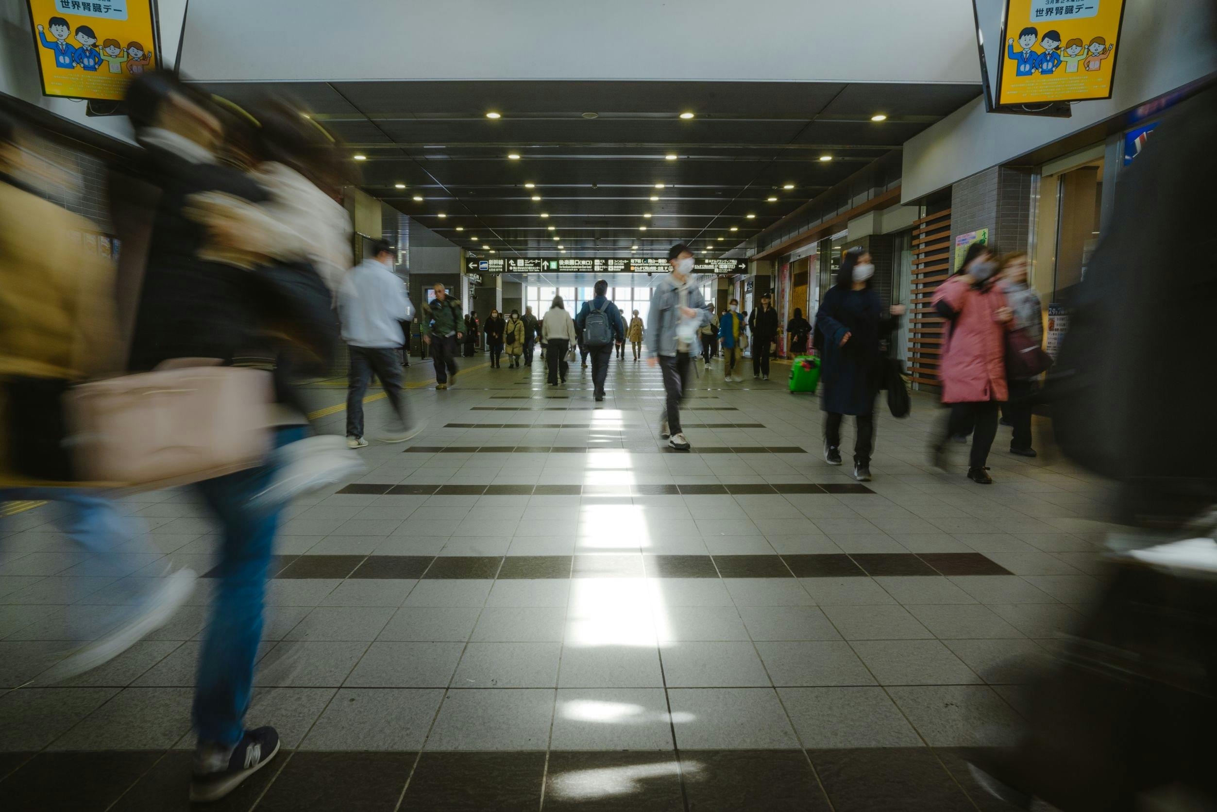 Crowds of people rushing through Taipei City Station, capturing urban life and daily commute.